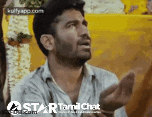 A Man Is Talking In Front Of A Yellow Wall With The Words Star Tamil Chat On The Bottom GIF