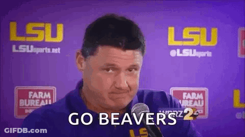 A Man Is Talking Into A Microphone And Says `` Go Beaver '' . GIF