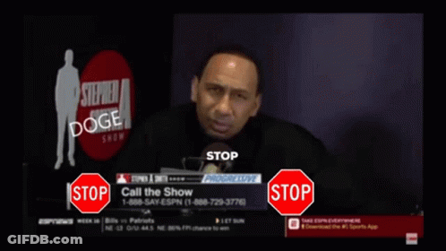 A Man Is Talking Into A Microphone While A Stop Sign Is In Front Of Him GIF