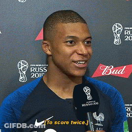 A Man Is Talking Into A Microphone While Wearing A Shirt That Says Russ GIF