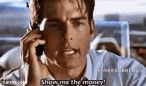 A Man Is Talking On A Cell Phone And Says `` Show Me The Money ! '' GIF