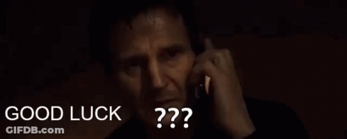A Man Is Talking On A Cell Phone And The Words `` Good Luck '' Are Visible Behind Him . GIF