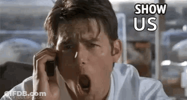 A Man Is Talking On A Cell Phone And Yawning . GIF