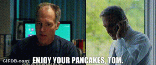 A Man Is Talking On A Cell Phone Next To Another Man Who Says Enjoy Your Pancakes , Tom . GIF
