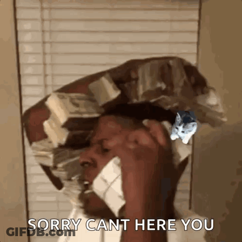 A Man Is Talking On A Cell Phone While Holding A Pile Of Money On His Head . GIF