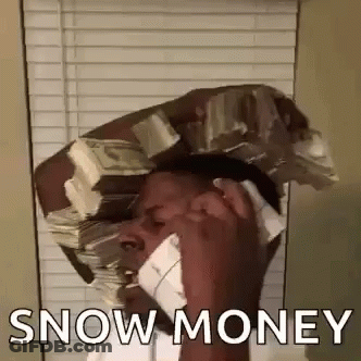 A Man Is Talking On A Cell Phone While Holding A Stack Of Money On His Head . GIF