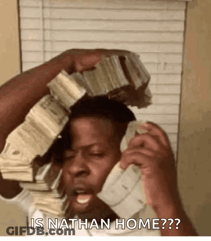 A Man Is Talking On A Cell Phone While Holding A Stack Of Money On Top Of His Head . GIF