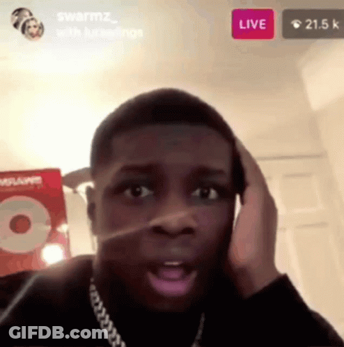 A Man Is Talking On A Cell Phone While Sitting In A Room . GIF