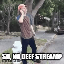 A Man Is Talking On A Cell Phone While Standing On The Side Of The Road . GIF