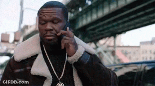 A Man Is Talking On A Cell Phone While Wearing A Fur Coat . GIF