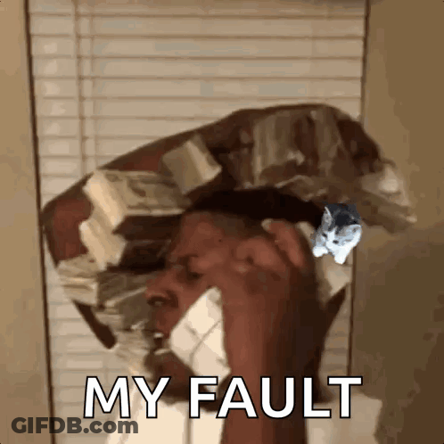 A Man Is Talking On A Cell Phone With A Cat On His Head . GIF