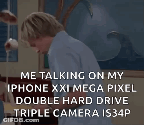 A Man Is Talking On A Cell Phone With A Double Hard Drive Triple Camera . GIF