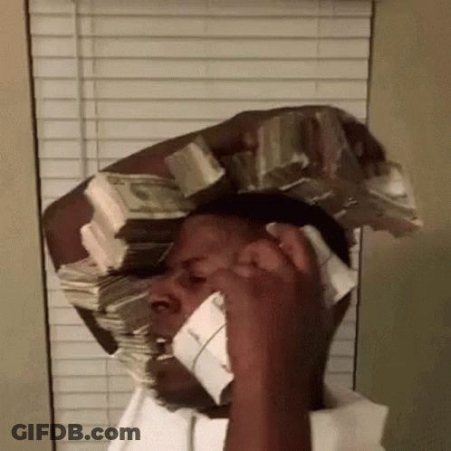 A Man Is Talking On A Cell Phone With A Large Stack Of Money On His Head . GIF