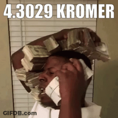 A Man Is Talking On A Cell Phone With A Stack Of Money On His Head GIF