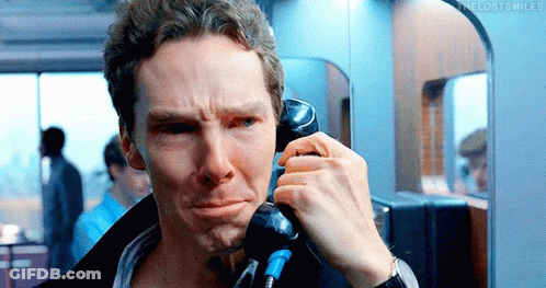 A Man Is Talking On A Pay Phone And Making A Sad Face GIF