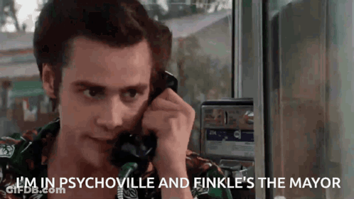A Man Is Talking On A Pay Phone And Says `` I 'M In Psychoville And Finkle 'S The Mayor '' GIF