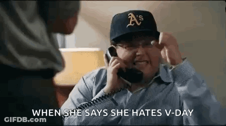 A Man Is Talking On A Phone While Wearing A Hat . GIF