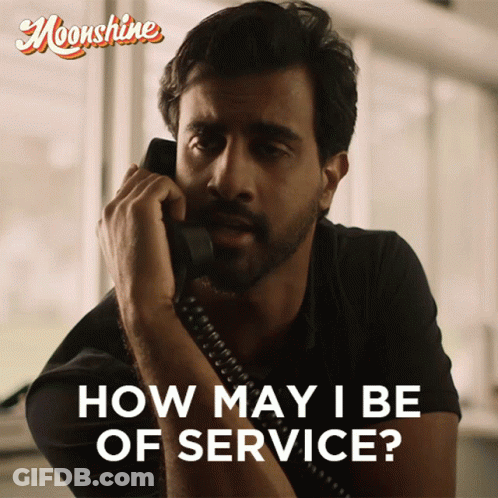 A Man Is Talking On A Phone With The Words How May I Be Of Service GIF
