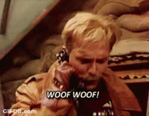A Man Is Talking On A Phone With The Words Woof Woof Written On The Bottom GIF