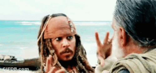 A Man Is Talking To A Man On A Beach . GIF
