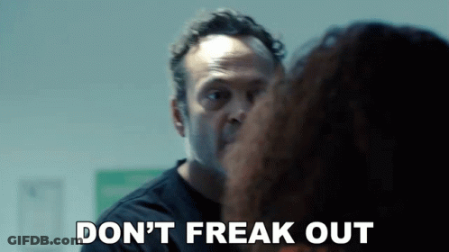 A Man Is Talking To A Woman And Says Do N't Freak Out . GIF