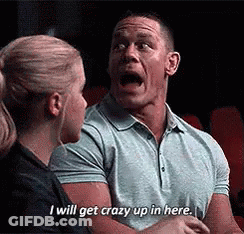 A Man Is Talking To A Woman In A Movie Theater And Saying `` I Will Get Crazy Up In Here '' . GIF