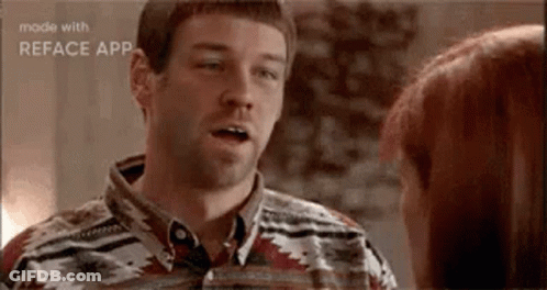 A Man Is Talking To A Woman In A Room . GIF