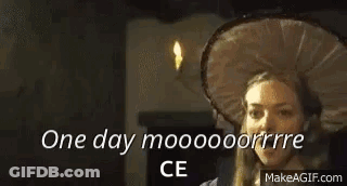 A Man Is Talking To A Woman In A Room With The Words `` One Day Mooooooorrre Ce '' Written On The Screen . GIF