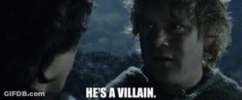 A Man Is Talking To Another Man And Says `` He 'S A Villain '' . GIF
