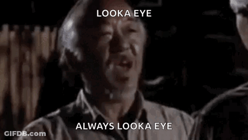 A Man Is Talking To Another Man In A Dark Room And Says `` Look A Eye , Always Look A Eye '' . GIF