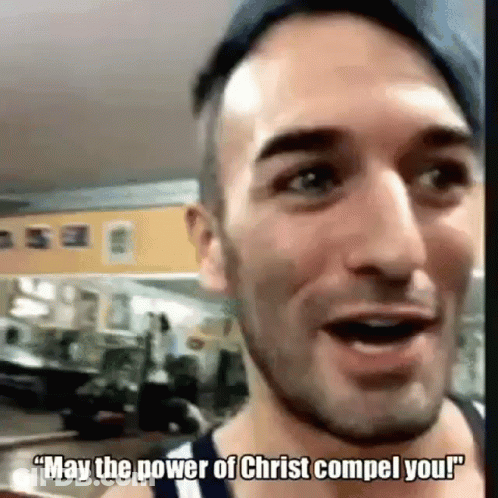 A Man Is Talking To Someone In A Gym And Saying `` May The Power Of Christ Comel You ! '' GIF