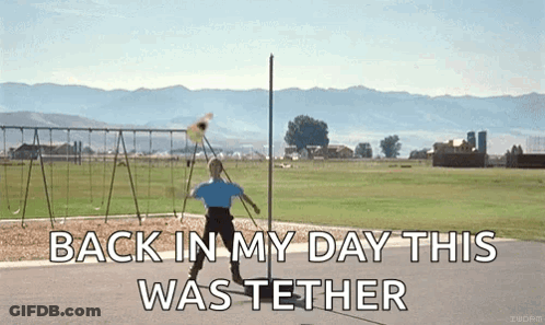 A Man Is Throwing A Frisbee In A Field With The Words " Back In My Day This Was Tether " On The Bottom GIF