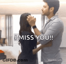 A Man Is Touching A Woman 'S Face And Saying `` I Miss You ! '' GIF