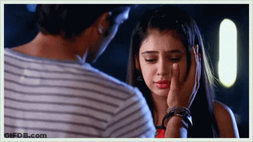 A Man Is Touching A Woman 'S Face And She Is Crying GIF