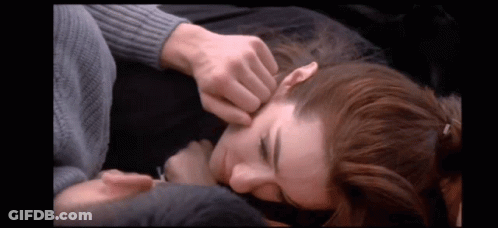 A Man Is Touching A Woman 'S Face In A Video GIF