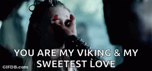 A Man Is Touching A Woman 'S Face With His Hand And Says `` You Are My Viking & My Sweetest Love '' . GIF