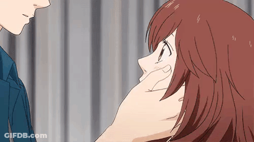 A Man Is Touching A Woman 'S Face With His Hand While They Are Looking At Each Other . GIF
