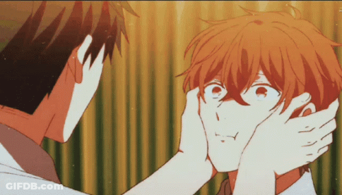A Man Is Touching Another Man 'S Face With His Hand GIF