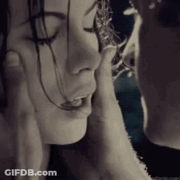 A Man Is Touching The Face Of A Woman In A Black And White Photo . GIF