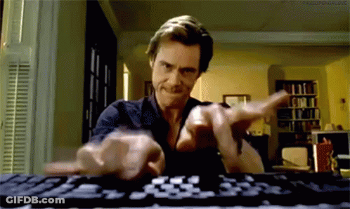 A Man Is Typing On A Keyboard In A Living Room GIF