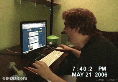 A Man Is Typing On A Keyboard In Front Of A Computer Screen Which Says May 21 2006 GIF