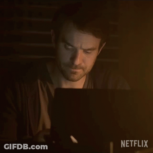 Man Using Laptop In Dark Room GIF