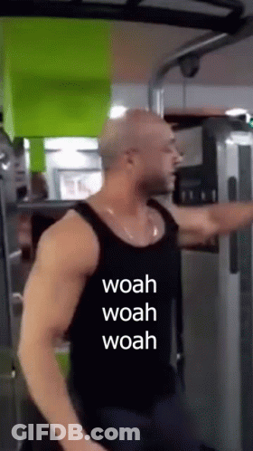 A Man Is Using A Machine In A Gym With The Words Woah Woah Woah Written On His Shirt . GIF
