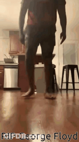 A Man Is Walking Barefoot In A Kitchen With The Words Rip George Floyd Written On The Bottom GIF