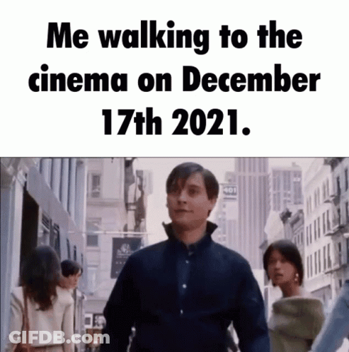 A Man Is Walking Down A City Street With A Caption That Says Me Walking To The Cinema On December 17Th 2021 GIF