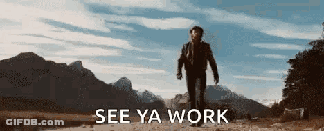 A Man Is Walking Down A Dirt Road With Mountains In The Background And The Words `` See Ya Work '' Below Him . GIF