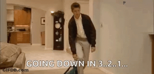 A Man Is Walking Down A Hallway In A Living Room With The Words `` Going Down In 3.2 . '' GIF