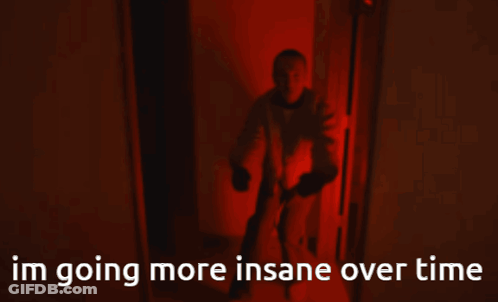A Man Is Walking Down A Hallway With The Words Im Going More Insane Over Time Behind Him GIF