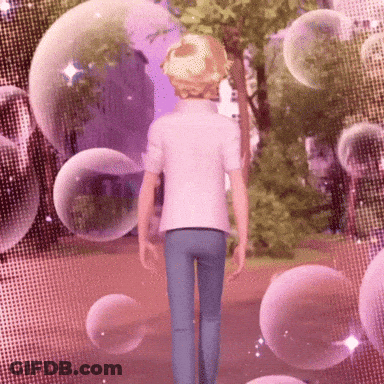 A Man Is Walking Down A Path With Bubbles Surrounding Him GIF