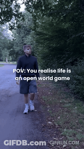 A Man Is Walking Down A Path With The Words " You Realise Life Is An Open World Game " GIF